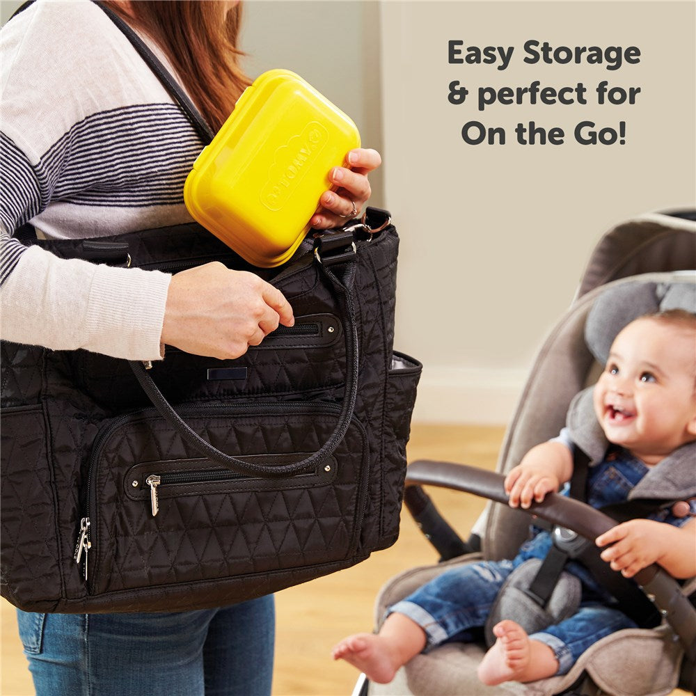 Woman putting closed Tomy Hide & Squeak Eggs container in nappy bag