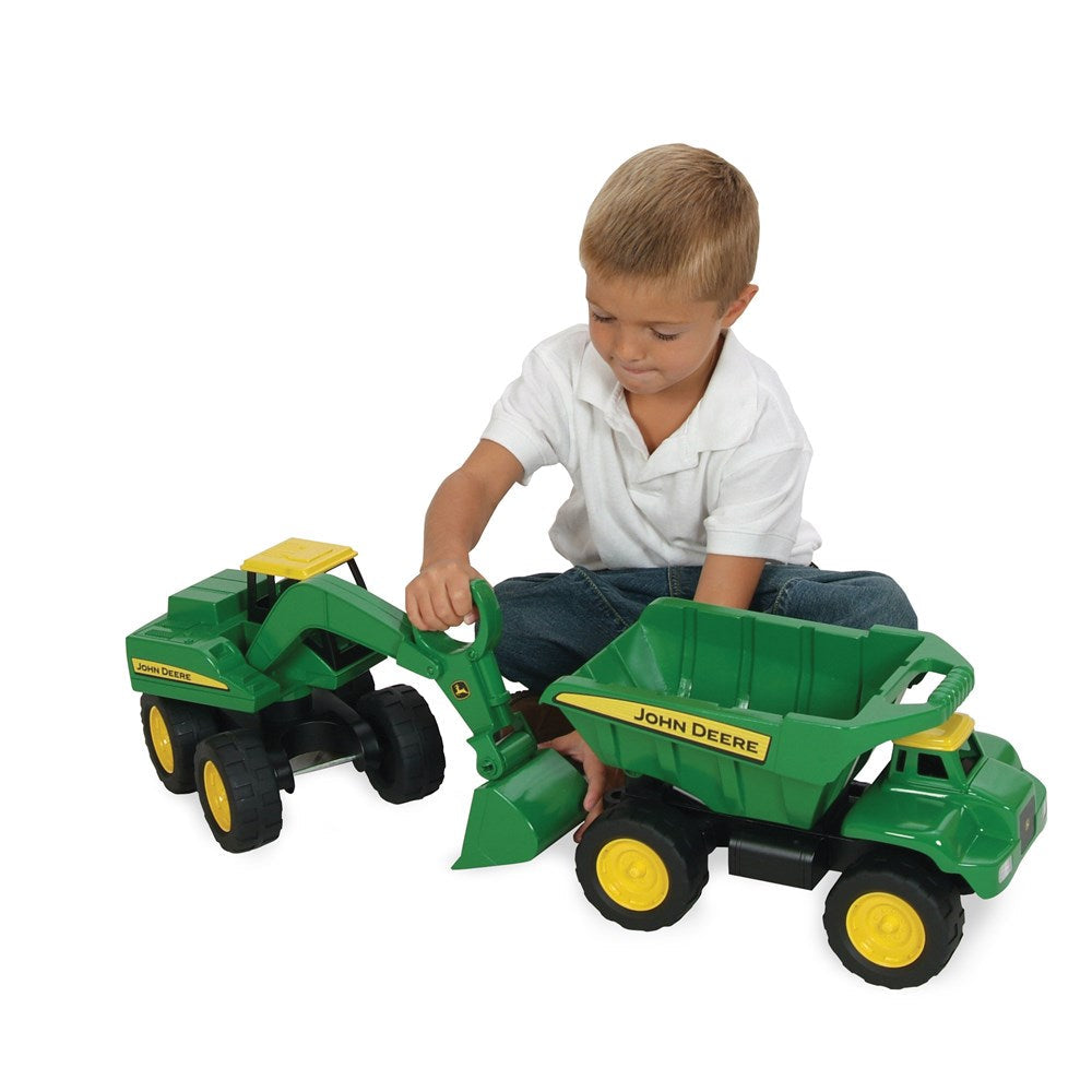 Child playing with John Deere Toy Big Scoop Excavator and Dump Truck